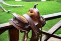Beautiful leather horse saddle on a wooden fence. Royalty Free Stock Photo