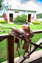 Beautiful leather horse saddle on a wooden fence. Royalty Free Stock Photo