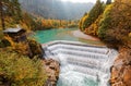Beautiful Lech Waterfall cascading down from an emerald lake surrounded by autumn colors of lakeside forests in Fussen, Bavaria Royalty Free Stock Photo