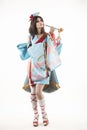 Beautiful leggy busty cosplayer girl wearing a stylized Japanese kimono costume cheerfully posing holding a fake pipe in the wind