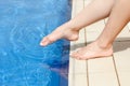 beautiful legs of a girl near a swimming pool on the sea background Royalty Free Stock Photo