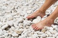 beautiful legs on a rocky beach. woman feet on front of sea rocky beach.