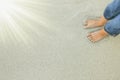 Beautiful legs on sand near the sea on nature background