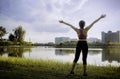 Beautiful life. Happy people lifestyle. Young woman in a nature park setting with her arms up in the air feeling free and energize Royalty Free Stock Photo