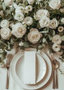 Beautiful light beige and white colors morning table decoration tablecloth and napkins, huge white roses blossom bouquet, silver Royalty Free Stock Photo