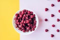 a beautiful light blue bowl of fruit with raspberries, blueberries and blackberries on yellow background, top view Royalty Free Stock Photo