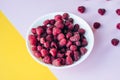 a beautiful light blue bowl of fruit with raspberries, blueberries and blackberries on yellow background, top view. Royalty Free Stock Photo