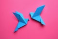 Beautiful light blue origami birds on pink background, flat lay Royalty Free Stock Photo