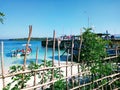 Beautiful light blue water of beach water two motor boat at beach view from fence wood