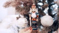 Beautiful light-colored toys hang on the Christmas tree at home. Nutcracker Royalty Free Stock Photo