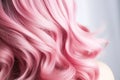 Beautiful light female hair, curls with pink strands, close-up, light background. Selective focus.