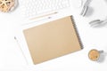 Beautiful light minimalistic mockup. White keyboard, mouse, headphones, pencils, sketchbook, vase with seashells and cup of cofee