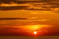 Beautiful light nature red sun in the golden sky and dark clouds seascape,Landscape nature background Golden sun Royalty Free Stock Photo