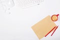 Beautiful light office mockup. White modern keyboard, mouse, headphones, sheet of craft paper, pencils and small red cup of coffee