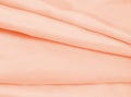 Beautiful light orange fabric with folds spread out waves Royalty Free Stock Photo
