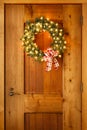 Beautiful lighted evergreen wreath with plaid fabric ribbon bow