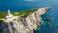 Beautiful lighthouse building at the end of a vertical cliff in Lefkada, Popular tourist destination in Grece