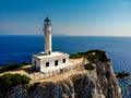 Beautiful lighthouse building at the end of a vertical cliff in Lefkada, Popular tourist destination in Grece