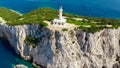 Beautiful lighthouse building at the end of a vertical cliff in Lefkada, Popular tourist destination in Grece