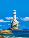 The beautiful Lighthouse Tourlitis of Chora at night. Andros island, Cyclades, Greece