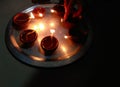 Beautiful lighting earthen lamps in plate kept in darkness