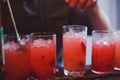 Beautiful line of different colored alcohol cocktails, tequila, martini, vodka, and others on decorated catering banquet table Royalty Free Stock Photo