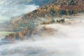 Beautiful Lingering Fog Over Autumn Colored Trees. Royalty Free Stock Photo