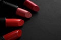 Beautiful lipsticks on black background, closeup. Space for text