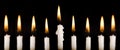 Beautiful lit hanukkah candles on black. Royalty Free Stock Photo