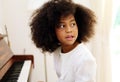 African American girl smile happy playing and learning piano classroom in holiday weekend at home. Royalty Free Stock Photo
