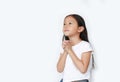 Beautiful little asian child girl praying isolated over white background with looking up. Spirituality and religion concept Royalty Free Stock Photo