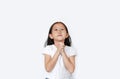 Beautiful little asian child girl praying isolated over white background with looking up. Spirituality and religion concept Royalty Free Stock Photo