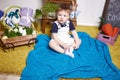 Beautiful little baby boy sitting on a chair with a knitted Royalty Free Stock Photo