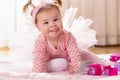 Baby girl crawling on the nursery floor Royalty Free Stock Photo