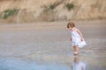 Beautiful little baby girl wearing white dress on beach Royalty Free Stock Photo