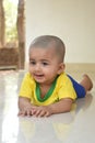 A beautiful little babygirl wearing a Brazilian football jersey.