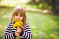 Beautiful little blonde girl, playing outdoor, springtime Royalty Free Stock Photo