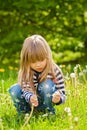 Beautiful little blonde girl, playing outdoor, springtime Royalty Free Stock Photo