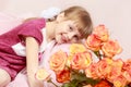 Little girl with a bouquet of tea roses. Royalty Free Stock Photo