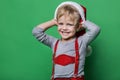 Beautiful little boy dressed like Santa Claus helper smiling. Christmas concept Royalty Free Stock Photo