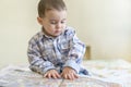 A beautiful little boy is looking at a big book Royalty Free Stock Photo