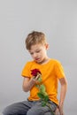 Beautiful little boy toddler holding flower Mother day concept