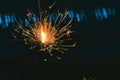 Beautiful little candle fireworks in glass bottle,hand holding sparkler on black background Royalty Free Stock Photo