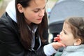 beautiful little cheerful smiling girl with her mother on a walk in the street Royalty Free Stock Photo