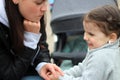 beautiful little cheerful smiling girl with her mother on a walk in the street Royalty Free Stock Photo