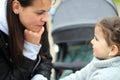 beautiful little cheerful smiling girl with her mother on a walk in the street Royalty Free Stock Photo