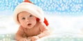 Beautiful Little Child Is Celebrating Christmas. New Year`s Holiday. A Child In A Christmas Costume. Happy Newborn Baby In Santa
