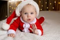 Beautiful Little Child Is Celebrating Christmas. New Year&#x27;s Holidays. A Child In A Christmas Costume. Childhood And