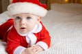 Beautiful Little Child Is Celebrating Christmas. New Year&#x27;s Holidays. A Child In A Christmas Costume. Childhood And