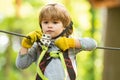 Beautiful little child climbing and having fun in adventure Park. Eco Resort Activities. Cute baby boy playing. Hike and Royalty Free Stock Photo